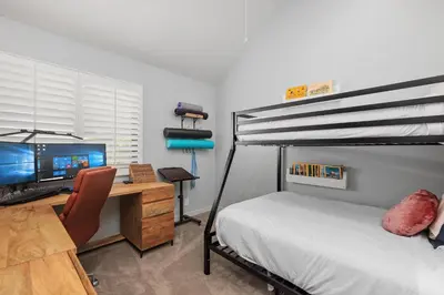a bedroom with a bed and a desk with a computer at Breeze & Bridle - TC530J in Solana Beach