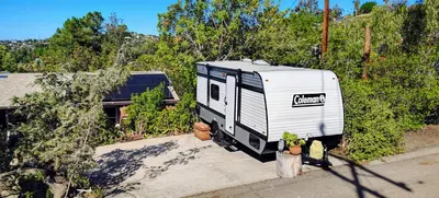 an rv parked on the side of a driveway at The Owl House in Spring Valley