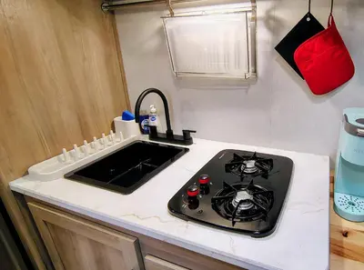 a kitchen with a stove and a sink at The Owl House in Spring Valley