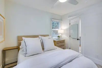 a white bed with white pillows in a bedroom at half Mi to Balboa Park Cottage with Private Yard! in San Diego