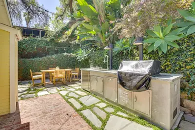 a backyard with a grill and a table and a patio at half Mi to Balboa Park Cottage with Private Yard! in San Diego