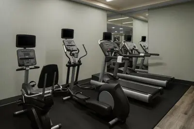 a gym with a row of treadmills and machines at Courtyard by Marriott San Diego Gaslamp/Convention Center in San Diego