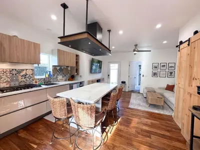 a kitchen with a table and chairs in a room at Oceanside Rooftop Retreat Sleeps 4 in Oceanside