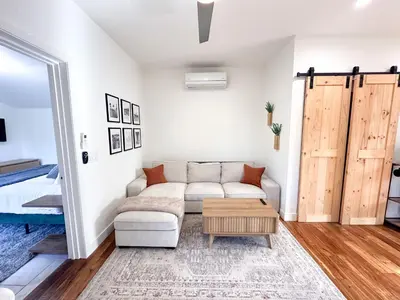 a living room with a couch and a table at Oceanside Rooftop Retreat Sleeps 4 in Oceanside