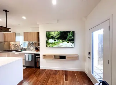 a kitchen with white walls and a large window at Oceanside Rooftop Retreat Sleeps 4 in Oceanside