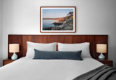 a bedroom with a white bed and two lamps at Sentral Gaslamp Quarter in San Diego