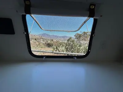a view of the desert from a window of a bus at Stay in Style - Airstream & Views in Spring Valley