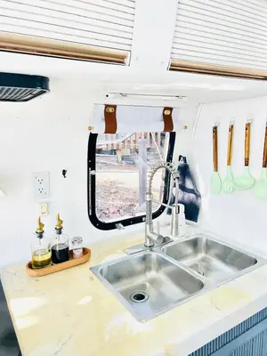 a kitchen with a sink in a caravan at Stay in Style - Airstream & Views in Spring Valley