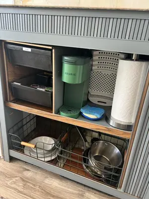 a cabinet filled with dishes and other kitchen utensils at Stay in Style - Airstream & Views in Spring Valley