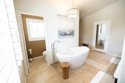 a bathroom with a white tub and a toilet at Wine Country Villa in Temecula