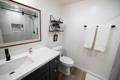 a white bathroom with a sink and a toilet at Wine Country Villa in Temecula