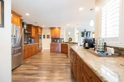 a large kitchen with wooden cabinets and a counter top at Wine Country Villa in Temecula
