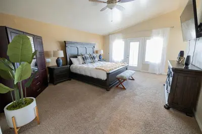 a bedroom with a bed and a plant in it at Wine Country Villa in Temecula