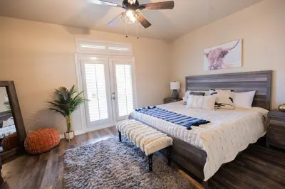 a bedroom with a large bed and a ceiling fan at Wine Country Villa in Temecula