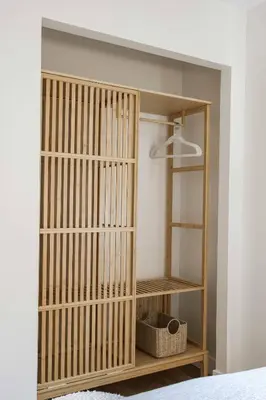 a wooden book shelf in a bedroom with a lamp at Chic Surf Lodge with Hot Tub & Ocean Views in Oceanside