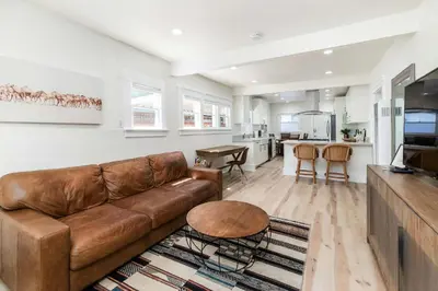 a living room with a couch and a kitchen at Modern Gem in North Park in San Diego