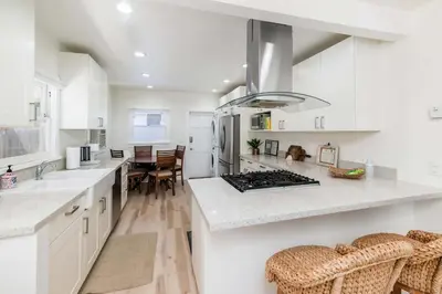 a kitchen with white cabinets and a counter top at Modern Gem in North Park in San Diego
