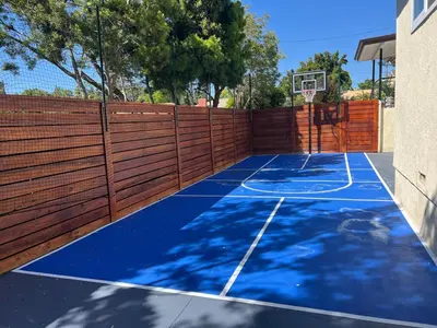 a tennis court with a fence and a basketball hoop at Large 5BR Family Haven w Sports court Game Room Backyard in La Mesa