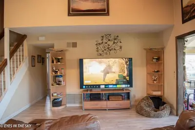 a living room with a flat screen tv in the wall at Big Beautiful Master Bedroom in Bonita