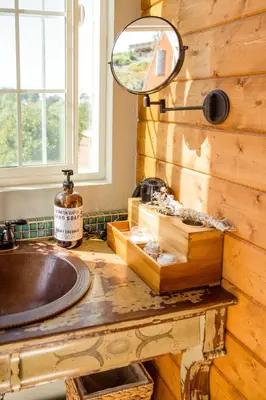 a bathroom with a sink and a mirror on a counter at African-Inspired Safari Tent near San Diego for a Glamping Weekend in Vista, California in Vista