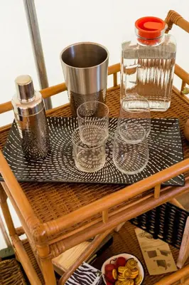 a tray with glasses and a bottle on a table at African-Inspired Safari Tent near San Diego for a Glamping Weekend in Vista, California in Vista