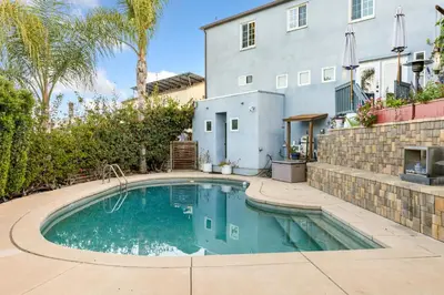 a swimming pool in front of a house at Luxurious Pool & Sauna Home with Beautiful Gardens in San Diego
