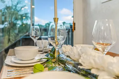 a table with wine glasses and plates on it at Luxurious Pool & Sauna Home with Beautiful Gardens in San Diego