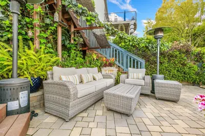 a patio with wicker chairs and a couch at Luxurious Pool & Sauna Home with Beautiful Gardens in San Diego