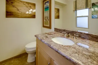 a bathroom with a sink and a toilet at Sail Bay Luxury Retreat With Private Spa and Rooftop Bay View in San Diego