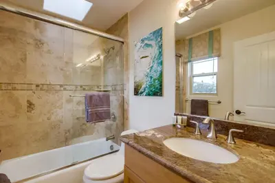 a bathroom with a sink and a shower at Sail Bay Luxury Retreat With Private Spa and Rooftop Bay View in San Diego