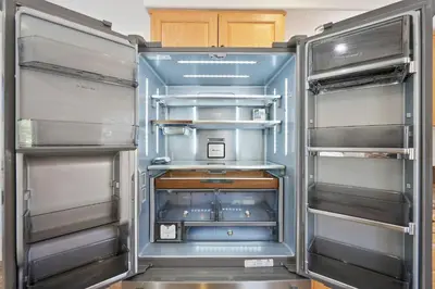 an empty refrigerator with its door open in a kitchen at Sail Bay Luxury Retreat With Private Spa and Rooftop Bay View in San Diego