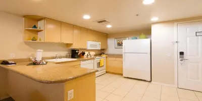 a kitchen with a white refrigerator and a counter at Grand Pacific Palisades in Carlsbad