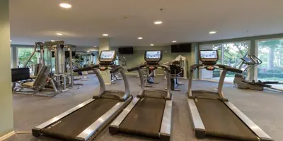 a gym with several tread machines in a room at Grand Pacific Palisades in Carlsbad