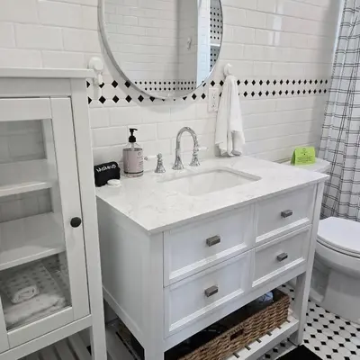 a white bathroom with a sink and a mirror at Wise in San Diego
