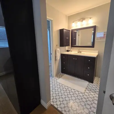 a bathroom with a sink and a mirror at Wise in San Diego