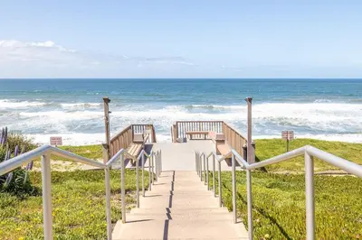 a stairway to the beach with the ocean in the background at Sea Bluff - Direct Beach Access in Encinitas