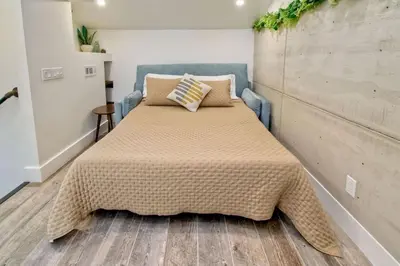 a bedroom with a bed with a blanket on it at Sea Bluff - Direct Beach Access in Encinitas