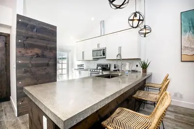 a kitchen with a large counter with two chairs at Sea Bluff - Direct Beach Access in Encinitas