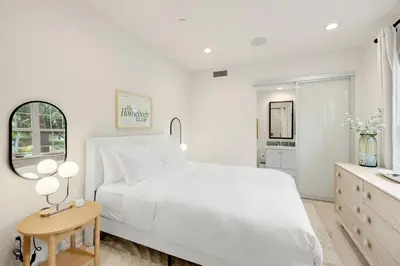a white bedroom with a white bed and a table at Grand Luxury 4BD Estate in Irvine in Irvine