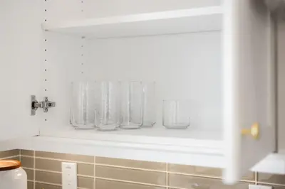 a white kitchen with white towels on a shelf at Grand Luxury 4BD Estate in Irvine in Irvine