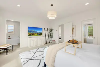 a white bedroom with a bed and a table at Grand Luxury 4BD Estate in Irvine in Irvine