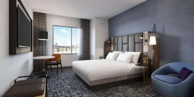 a hotel room with a bed and a chair at Tempo By Hilton San Diego Del Mar in San Diego