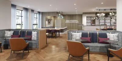 a restaurant with couches and tables and a kitchen at Tempo By Hilton San Diego Del Mar in San Diego