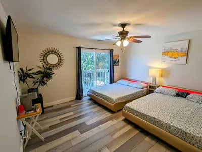 a bedroom with two beds and a ceiling fan at Entire Upstairs with 4 Bedrooms, 2 Baths and private entrance in San Diego