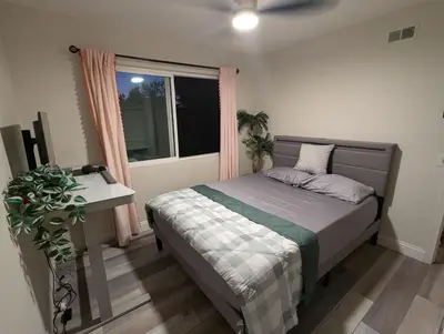 a bedroom with a bed and a desk and a window at Entire Upstairs with 4 Bedrooms, 2 Baths and private entrance in San Diego