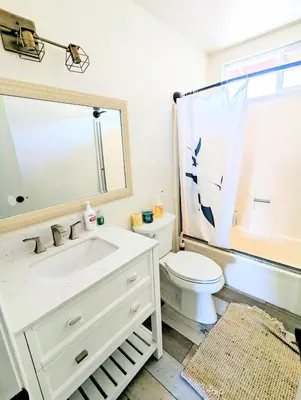 a bathroom with a white sink and a toilet at Entire Upstairs with 4 Bedrooms, 2 Baths and private entrance in San Diego