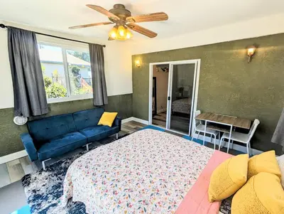a bedroom with a bed and a blue couch at Entire Upstairs with 4 Bedrooms, 2 Baths and private entrance in San Diego