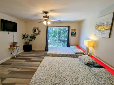a room with three beds and a ceiling fan at Entire Upstairs with 4 Bedrooms, 2 Baths and private entrance in San Diego
