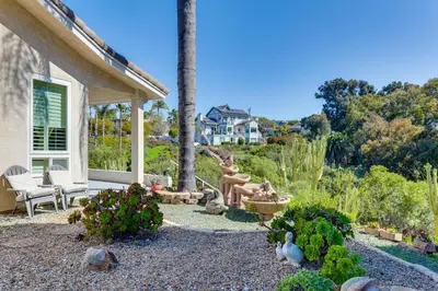 a garden with a statue in the middle of a yard at 3 Mi to Beach Central and Elegant Home in Oceanside in Oceanside