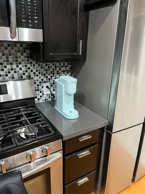 a small kitchen with a stove and a refrigerator at Stunning, Quiet Vista Retreat Minutes from Beach in Vista